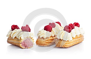 Raspberry eclairs isolated on white.