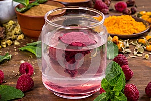 Raspberry extract is stirred in water