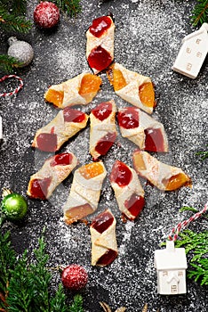 Raspberry filled bow tie cookies kolaczki on a Christmas rustic background photo