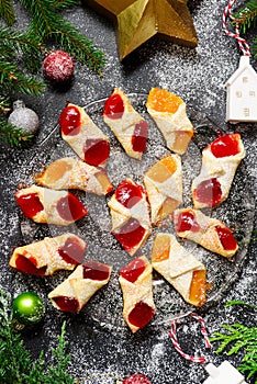 Raspberry filled bow tie cookies kolaczki on a Christmas rustic background photo