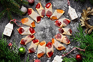 Raspberry filled bow tie cookies kolaczki on a Christmas rustic background photo