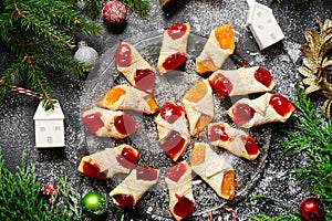 Raspberry filled bow tie cookies kolaczki on a Christmas rustic background photo