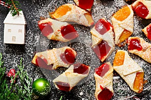 Raspberry filled bow tie cookies kolaczki on a Christmas rustic background photo