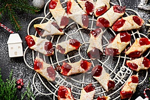 Raspberry filled bow tie cookies kolaczki on a Christmas rustic background photo