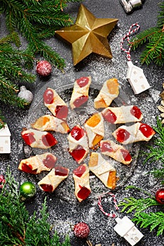 Raspberry filled bow tie cookies kolaczki on a Christmas rustic background photo