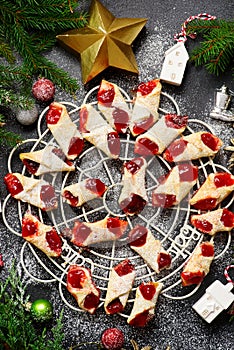 Raspberry filled bow tie cookies kolaczki on a Christmas rustic background photo