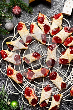 Raspberry filled bow tie cookies kolaczki on a Christmas rustic background photo