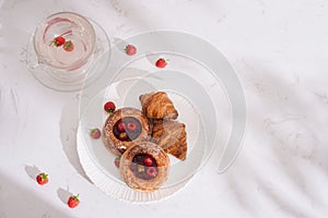 Raspberry filled pastries with sugar sprinkles. Selective focus photo