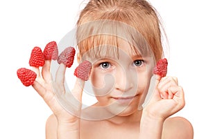Raspberry on fingers of a little girl