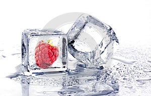 Raspberry frozen in ice cube. two ice cube