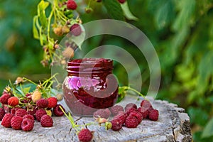 Raspberry jam in the garden. Selective focus.