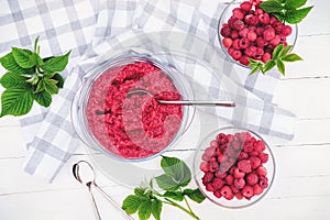 Raspberry jam making. berries and leaves