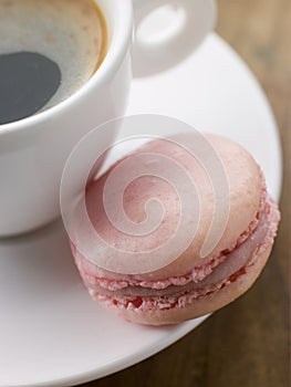 Raspberry Macaroon with a Cup of Espresso photo