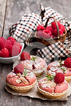 Raspberry macaroon tarts on wooden table