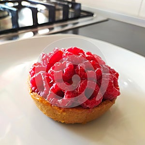 raspberry mini cake, tartlet on a table, close-up, isolated.