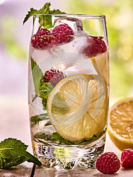 Raspberry mojito with cubes ice glass. Outdoor.