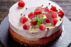 Raspberry mousse cake on a slate black plate