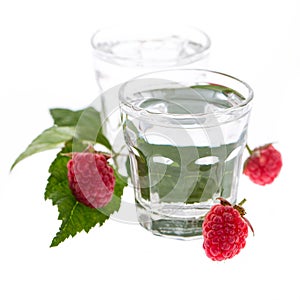 Raspberry schnapps with raspberries isolated on white background