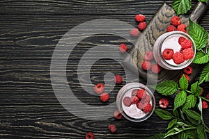 Raspberry smoothie in glass jars with fresh berry and yogurt on vintage wooden kitchen table background, flat lay, top view