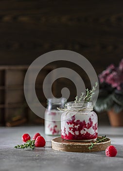 Raspberry smoothie, milkshake in a glass jar on a dark wooden background. Natural summer detox drink. Healthy eating concept