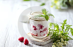 Raspberry smoothie, milkshake in a glass jar on a light background. Yogurt cocktail. Natural summer detox drink