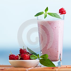 Raspberry smoothie with a mint, healthy beverage for people on a diet. Milkshake with berries