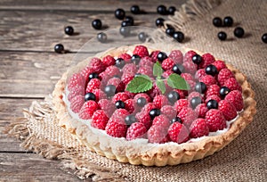 Raspberry tart pie with whipped cream, blackberry