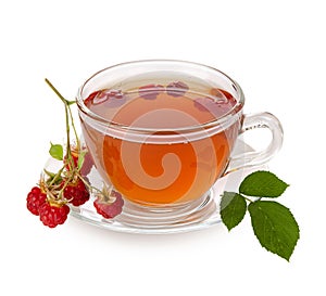Raspberry tea. Black tea hot drink in glass Cup with saucer and healthy red raw raspberry berry and leaf isolated on white