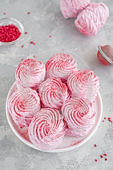 Raspberry zephyr, Russian marshmallows on a cake stand on a grey concrete background. Copy space, selective focus