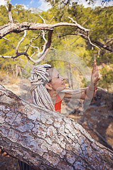 Rastafarian girl on a walk in a rocky forest