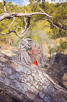 Rastafarian girl on a walk in a rocky forest
