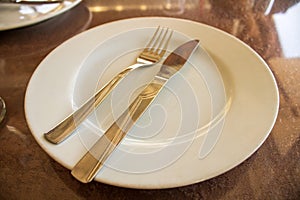 Empty plate with fork and spoon, waiting service on the table!