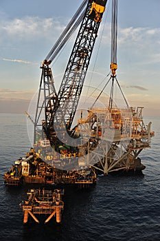 The RAT or Riser Access Truss is lifted from a barge offshore-Bass Strait