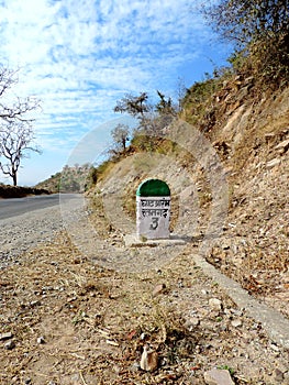 Signboard on the road showing start of the uphill climb of hill of Ratangarh Kheri in Madhya Pradesh, India tour photo