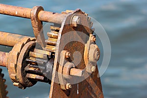 Ratchet and pawl mechanism of old rusty winch on a pier