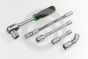 Ratchet wrench and different adapters with inserted interchangeable hexagonal sockets