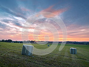 Ratingen, Germany - Beautiful sunset in the Bergisches Land region. Meadow in straw bales. Rural landscape