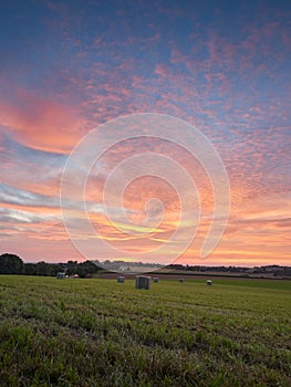 Ratingen, Germany - Beautiful sunset in the Bergisches Land region. Meadow in straw bales. Rural landscape