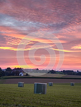 Ratingen, Germany - Beautiful sunset in the Bergisches Land region. Meadow in straw bales. Rural landscape