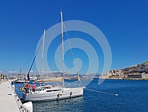 Ratonneau Island / France - may 8, 2017: Crew of sailingboat prepare our yacht to sailing. Litle yacht mooring near the pier in fr
