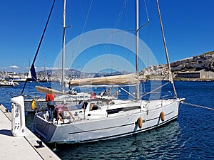 Ratonneau Island / France - may 8, 2017: Crew of sailingboat prepare our yacht to sailing. Litle yacht mooring near the pier in fr