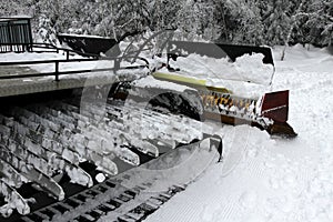 Ratrac. Ratrack, snow grooming machine prepares slopes for skiers on a ski resort in mountains. Ratrac machine for skiing slope pr