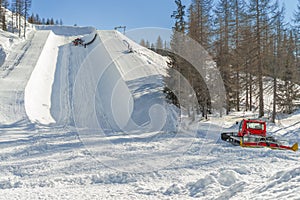 Ratrak making half pipe slope for snowboard and ski