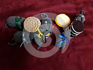 Rats with festive colorful ribbons around their neck gathered around sweets.