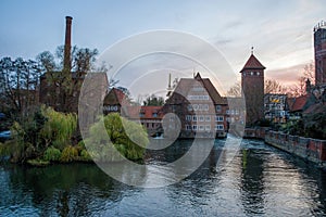 Ratsmuhle or old water mill and Wasserturm or water tower on the river Ilmenau in the morning in Luneburg. Germany.