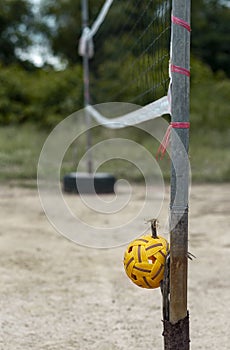 Rattan ball and mesh in rural empty ground sport court.