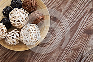 Rattan ball on wooden plate for decoration.