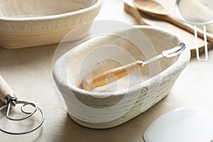 Rattan banneton, proofing basket for sourdough bread. Baking utensile. Basic set of baking bread at home photo