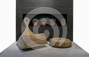 Rattan chair in wood tile back groung and 5 flowerpod
