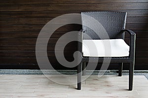 Rattan chair on wooden background